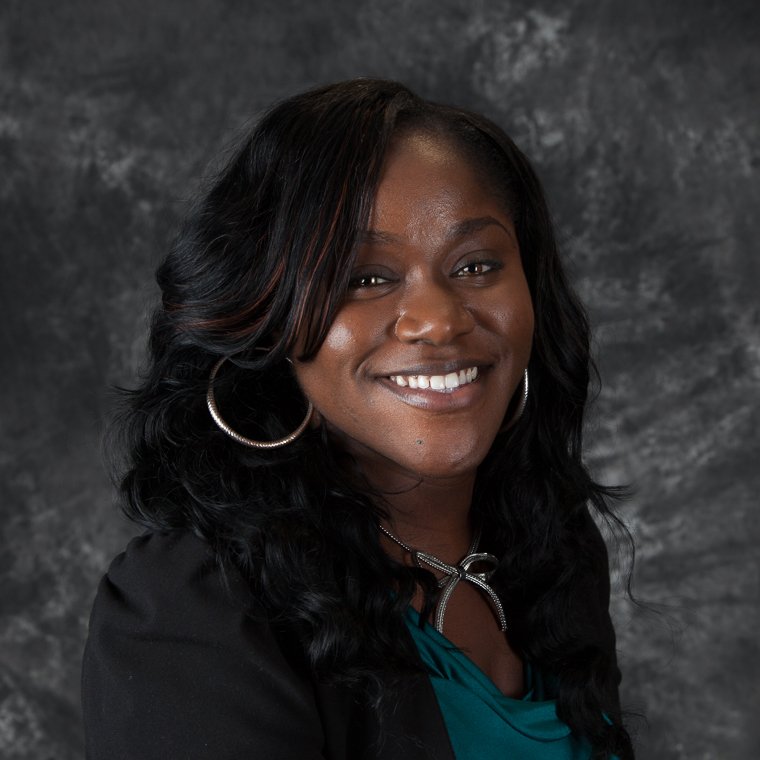 Finance professional headshot of a smiling woman on a dark background