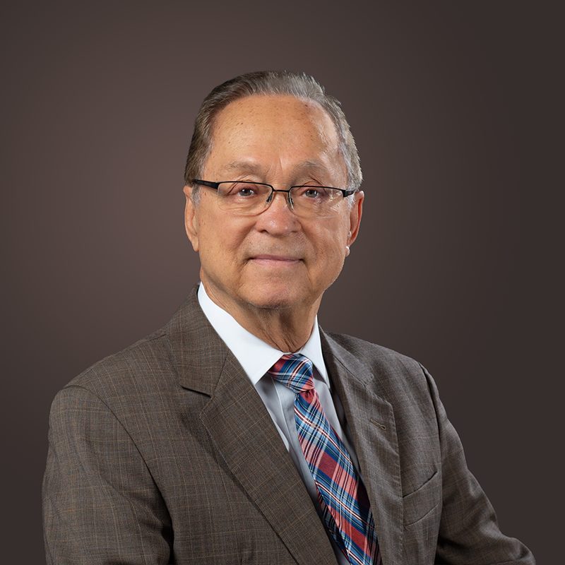 Finance professional headshot of a man in a grey tweed jacket and plaid tie